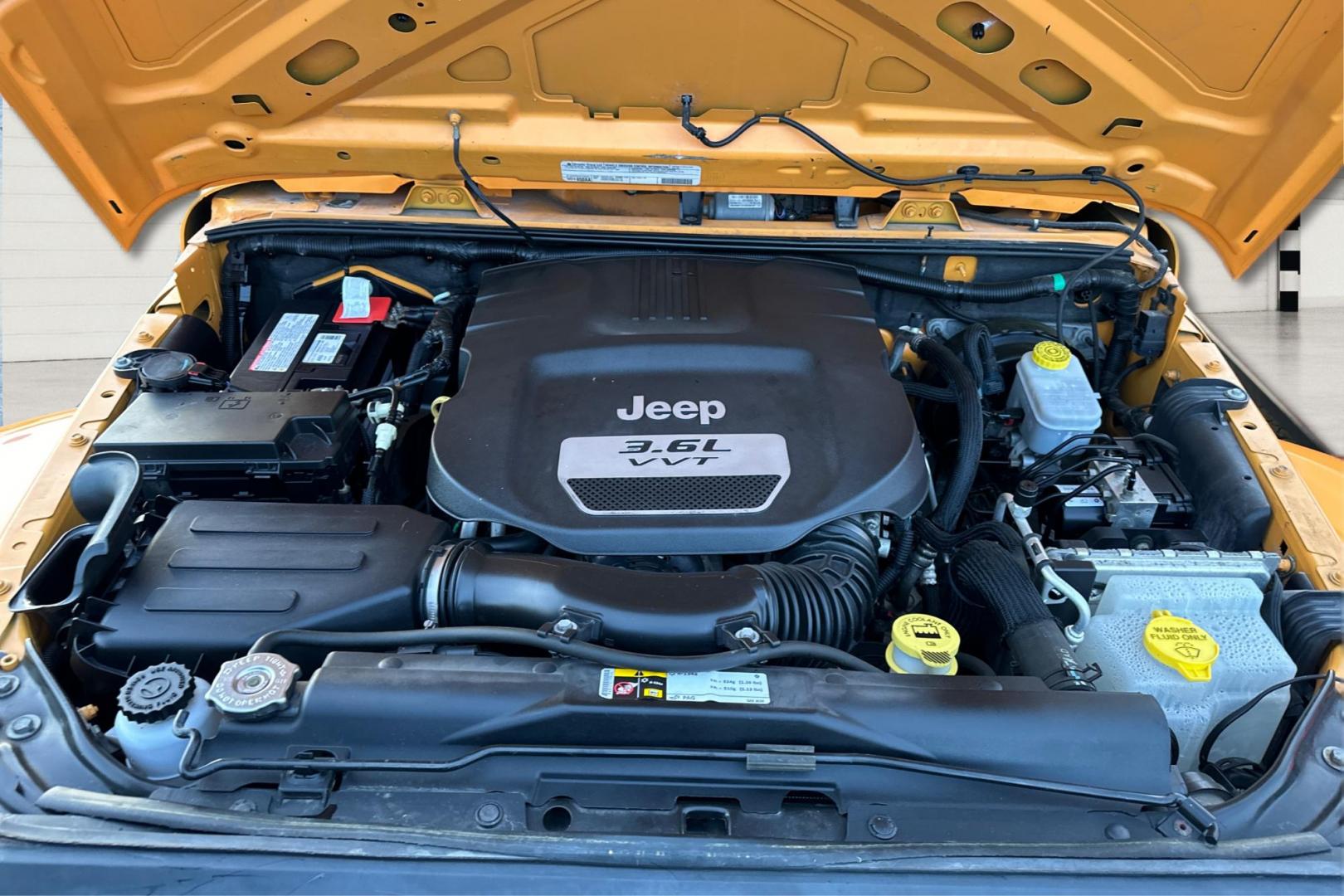 2012 Yellow Jeep Wrangler Unlimited Sahara 4WD (1C4BJWEG3CL) with an 3.6L V6 DOHC 24V FFV engine, Automatic, 5-Spd transmission, located at 7755 State Street, Midvale, UT, 84047, (801) 753-9063, 40.610329, -111.892159 - Photo#10