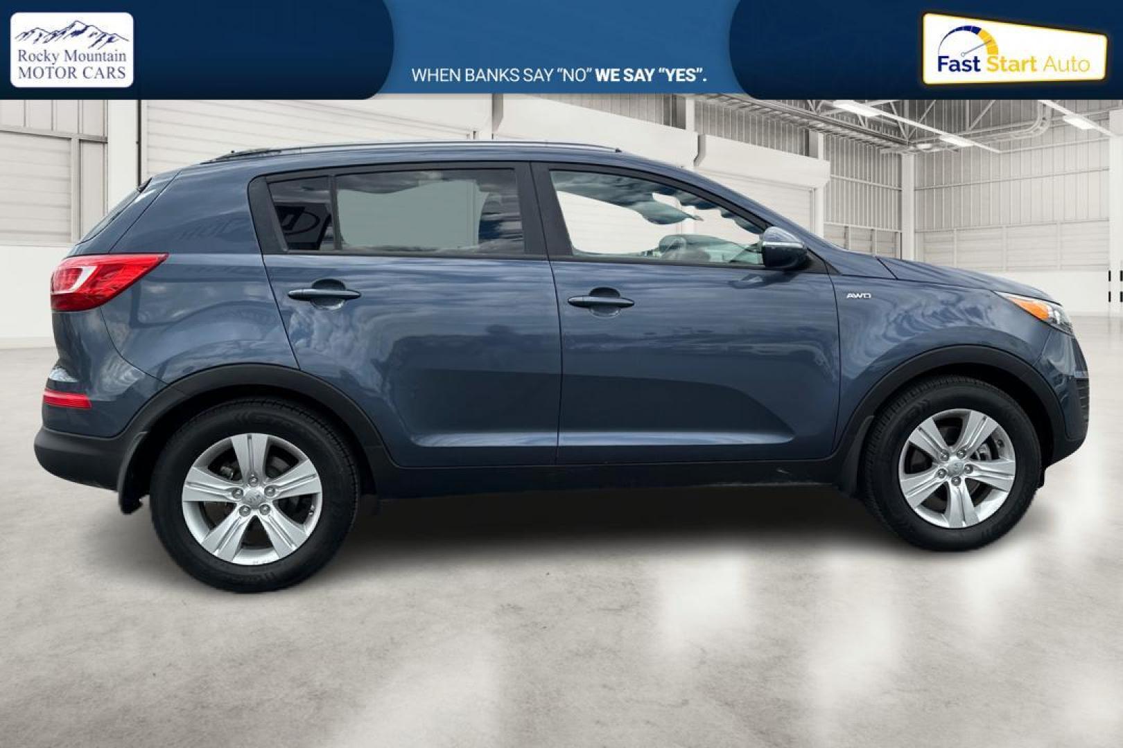 2012 Blue Kia Sportage LX AWD (KNDPBCA22C7) with an 2.4L V6 DOHC 24V engine, 6-Speed Automatic transmission, located at 344 S Washington Blvd, Ogden, UT, 84404, (801) 399-1799, 41.255482, -111.970848 - Photo#1