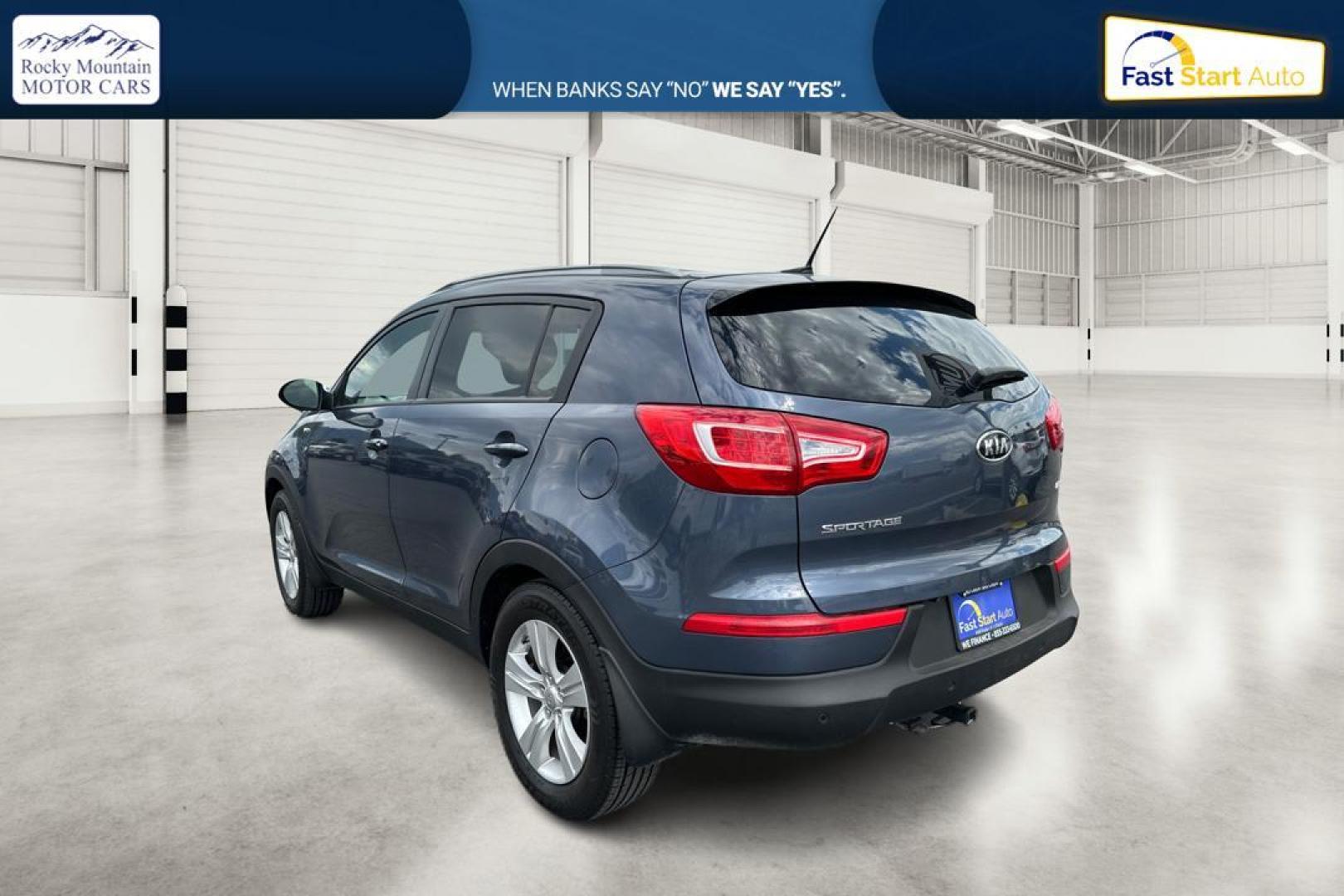 2012 Blue Kia Sportage LX AWD (KNDPBCA22C7) with an 2.4L V6 DOHC 24V engine, 6-Speed Automatic transmission, located at 344 S Washington Blvd, Ogden, UT, 84404, (801) 399-1799, 41.255482, -111.970848 - Photo#4