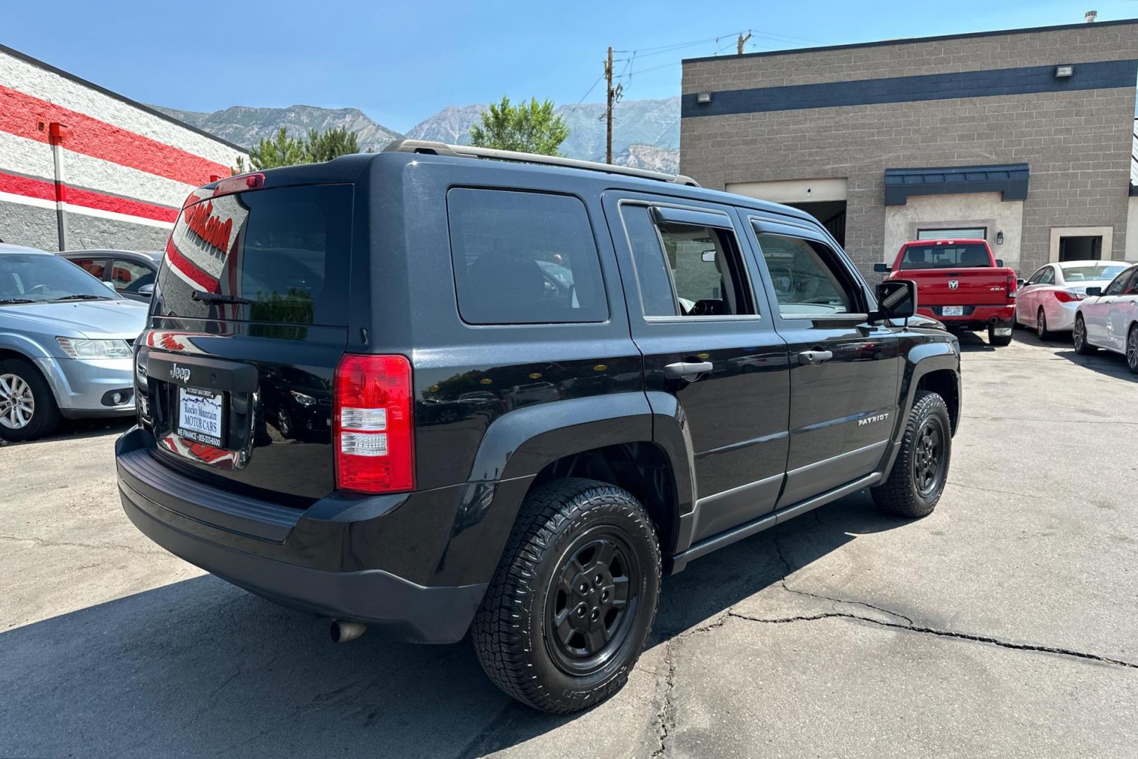 2014 Black Jeep Patriot Sport 2WD (1C4NJPBA2ED) with an 2.0L L4 DOHC 16V engine, Automatic, 6-Spd w/AutoStick transmission, located at 344 S Washington Blvd, Ogden, UT, 84404, (801) 399-1799, 41.255482, -111.970848 - Photo#2