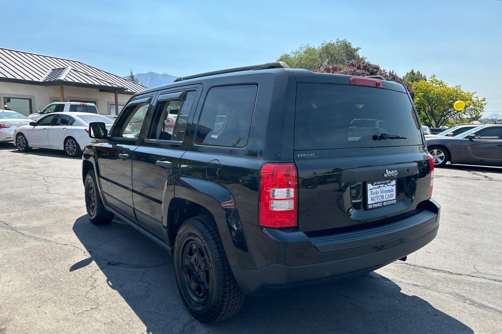 2014 Black Jeep Patriot Sport 2WD (1C4NJPBA2ED) with an 2.0L L4 DOHC 16V engine, Automatic, 6-Spd w/AutoStick transmission, located at 344 S Washington Blvd, Ogden, UT, 84404, (801) 399-1799, 41.255482, -111.970848 - Photo#4