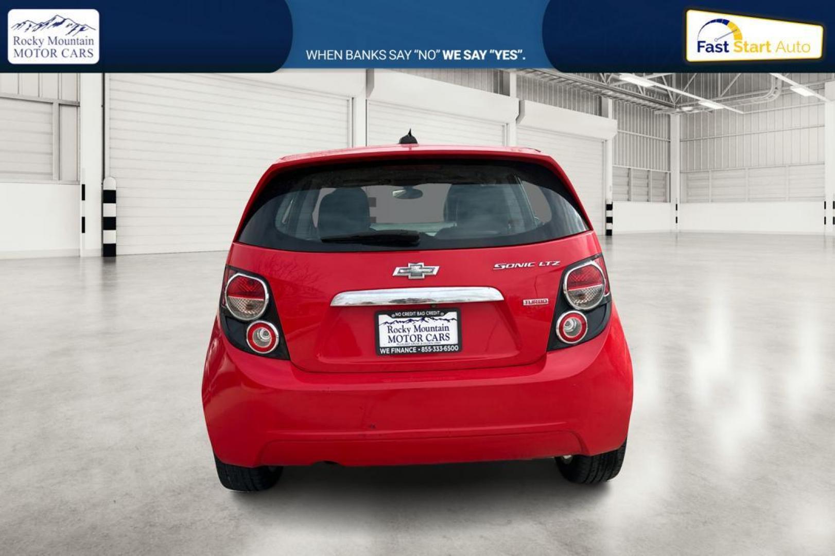 2015 Red Chevrolet Sonic LTZ Auto 5-Door (1G1JE6SB1F4) with an 1.4L L4 DOHC 24V TURBO engine, 6-Speed Automatic transmission, located at 767 S State Road, Pleasant Grove, UT, 84062, (801) 785-1058, 40.354839, -111.736687 - Photo#4