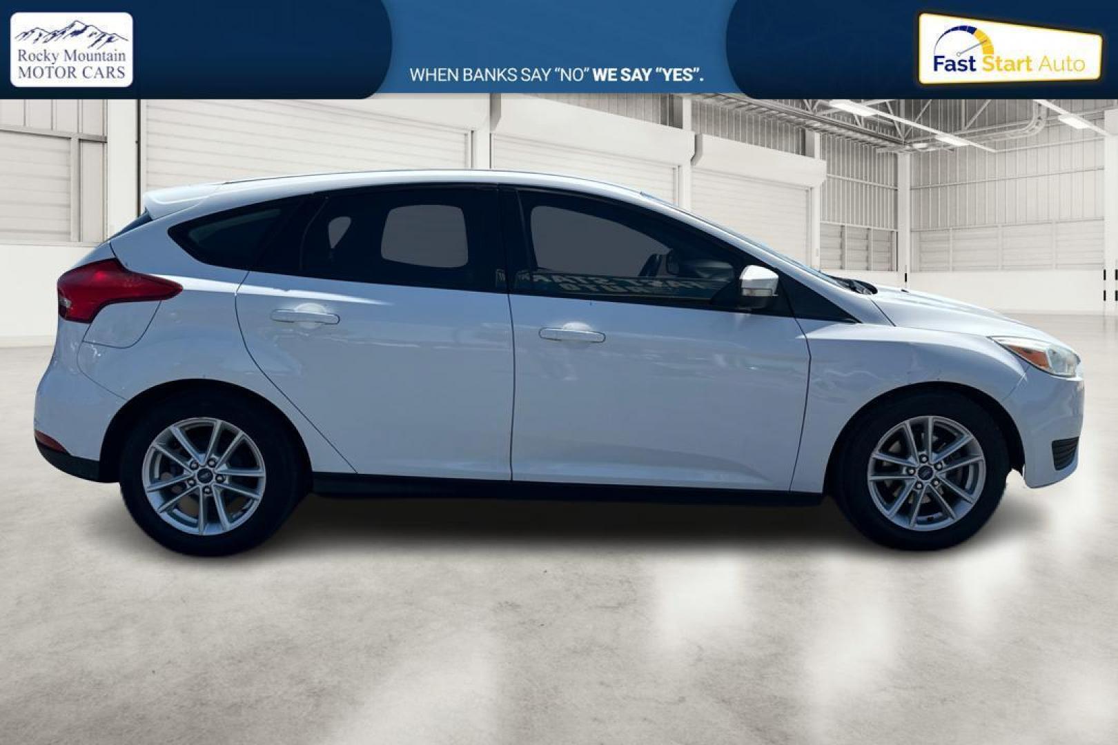 2015 White Ford Focus SE Hatch (1FADP3K23FL) with an 2.0L L4 DOHC 16V engine, 5-Speed Manual transmission, located at 7755 State Street, Midvale, UT, 84047, (801) 753-9063, 40.610329, -111.892159 - Photo#1