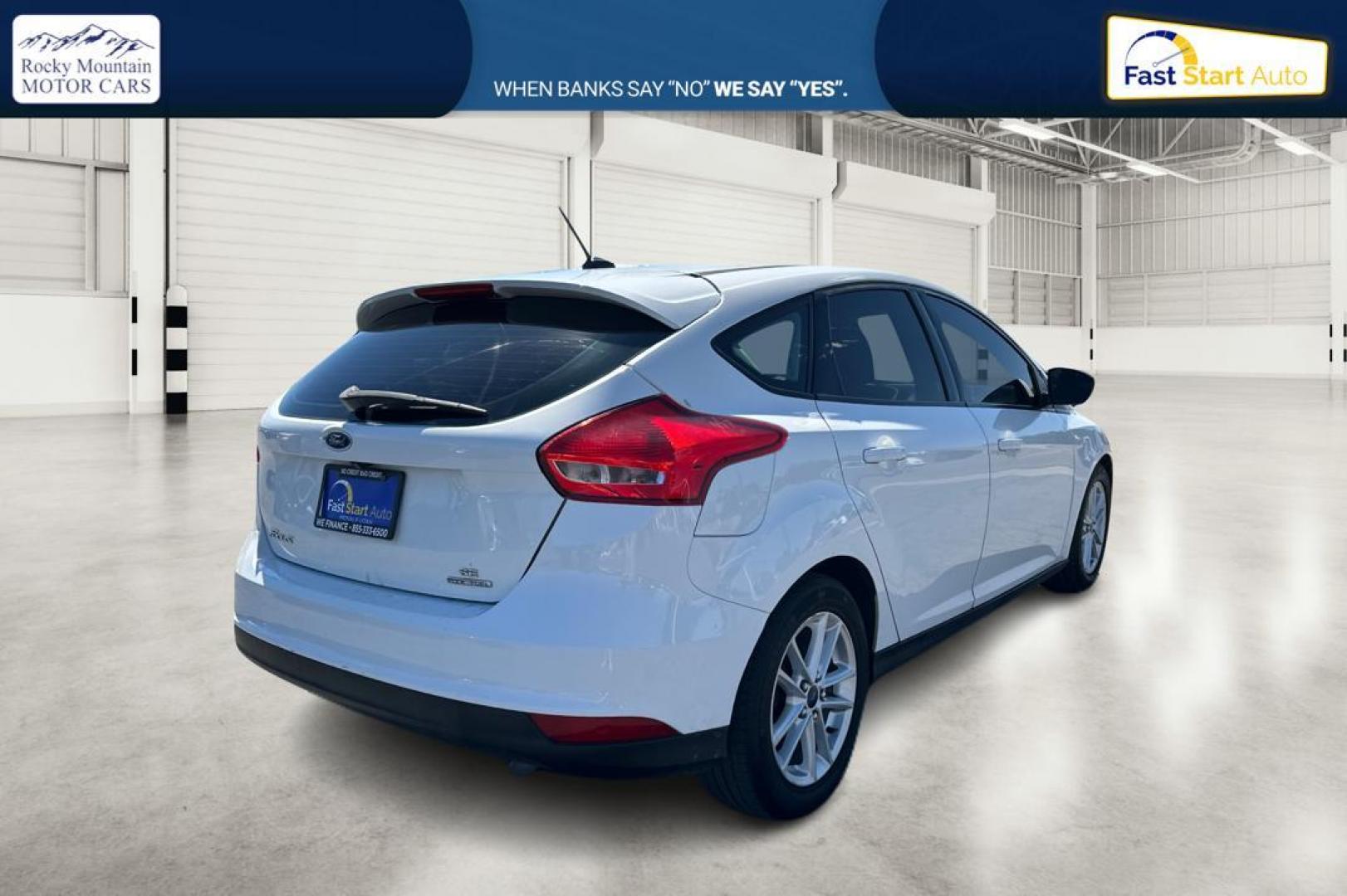 2015 White Ford Focus SE Hatch (1FADP3K23FL) with an 2.0L L4 DOHC 16V engine, 5-Speed Manual transmission, located at 7755 State Street, Midvale, UT, 84047, (801) 753-9063, 40.610329, -111.892159 - Photo#2