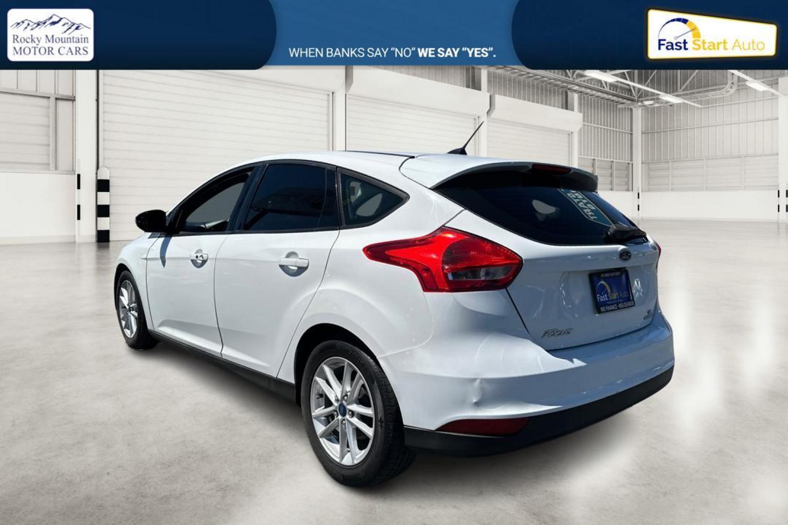 2015 White Ford Focus SE Hatch (1FADP3K23FL) with an 2.0L L4 DOHC 16V engine, 5-Speed Manual transmission, located at 7755 State Street, Midvale, UT, 84047, (801) 753-9063, 40.610329, -111.892159 - Photo#4