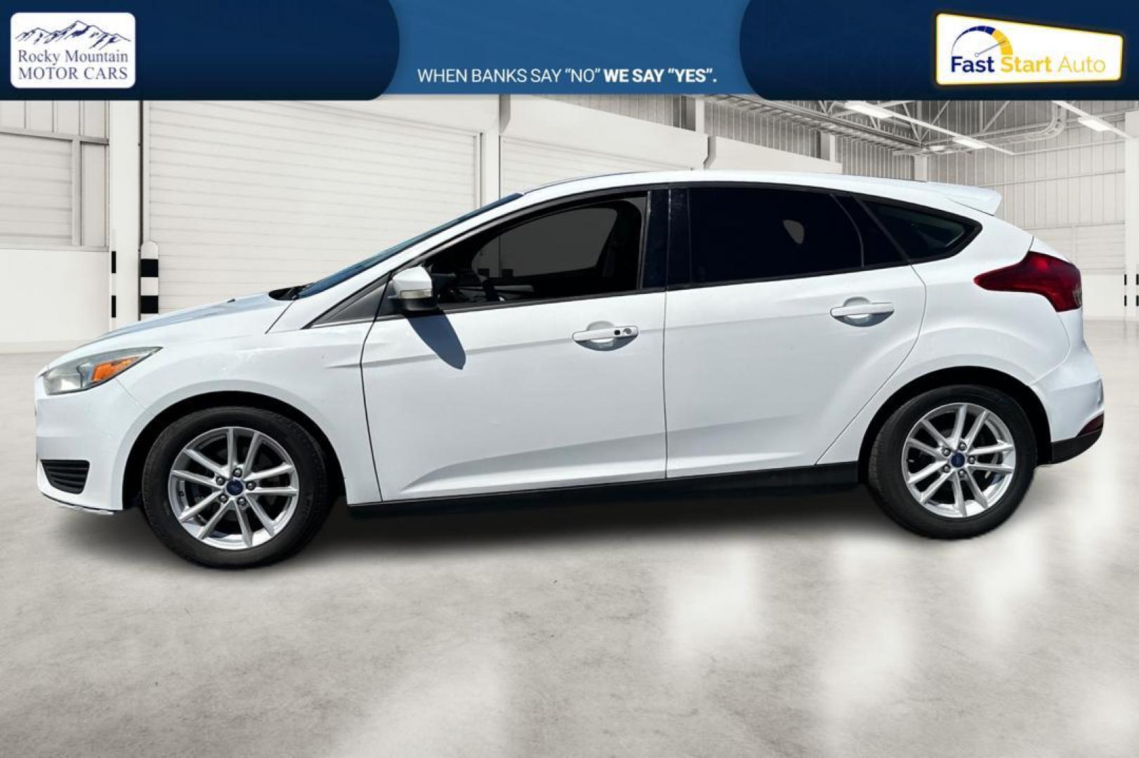 2015 White Ford Focus SE Hatch (1FADP3K23FL) with an 2.0L L4 DOHC 16V engine, 5-Speed Manual transmission, located at 7755 State Street, Midvale, UT, 84047, (801) 753-9063, 40.610329, -111.892159 - Photo#5