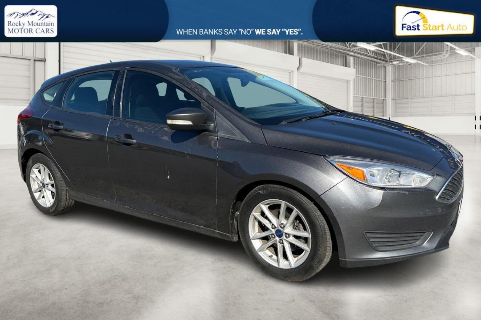 2015 Gray Ford Focus SE Hatch (1FADP3K22FL) with an 2.0L L4 DOHC 16V engine, 5-Speed Manual transmission, located at 344 S Washington Blvd, Ogden, UT, 84404, (801) 399-1799, 41.255482, -111.970848 - Photo#0