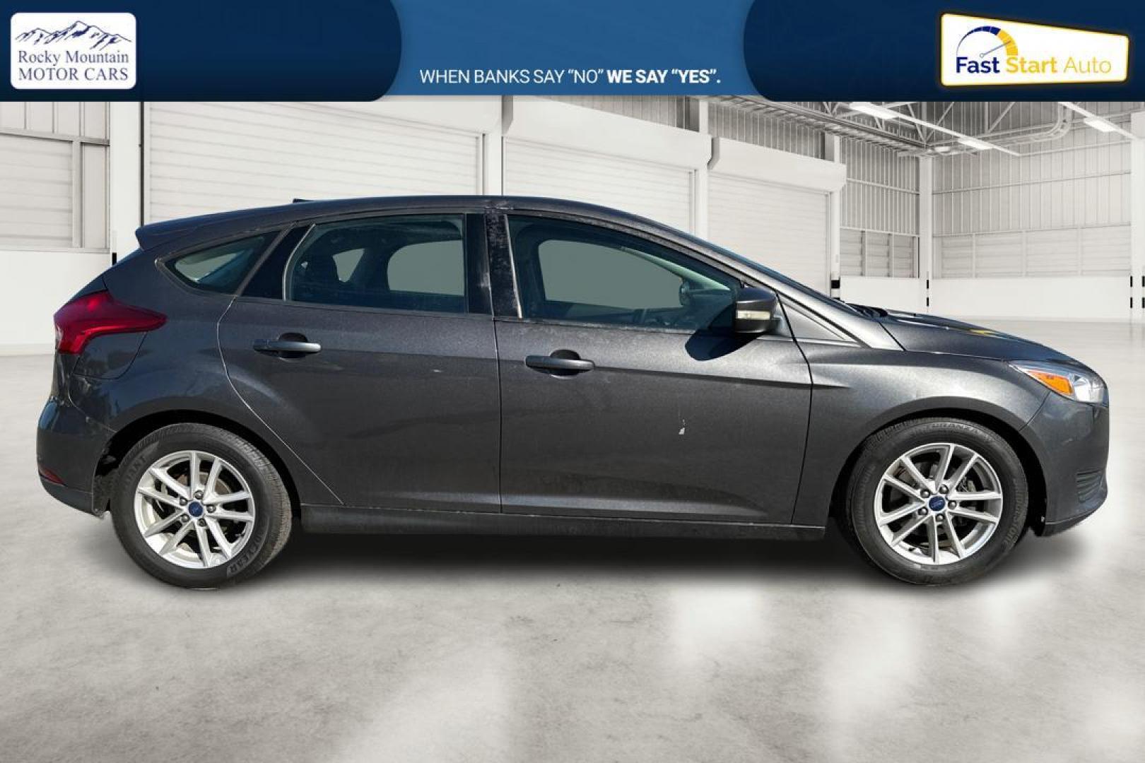 2015 Gray Ford Focus SE Hatch (1FADP3K22FL) with an 2.0L L4 DOHC 16V engine, 5-Speed Manual transmission, located at 344 S Washington Blvd, Ogden, UT, 84404, (801) 399-1799, 41.255482, -111.970848 - Photo#1