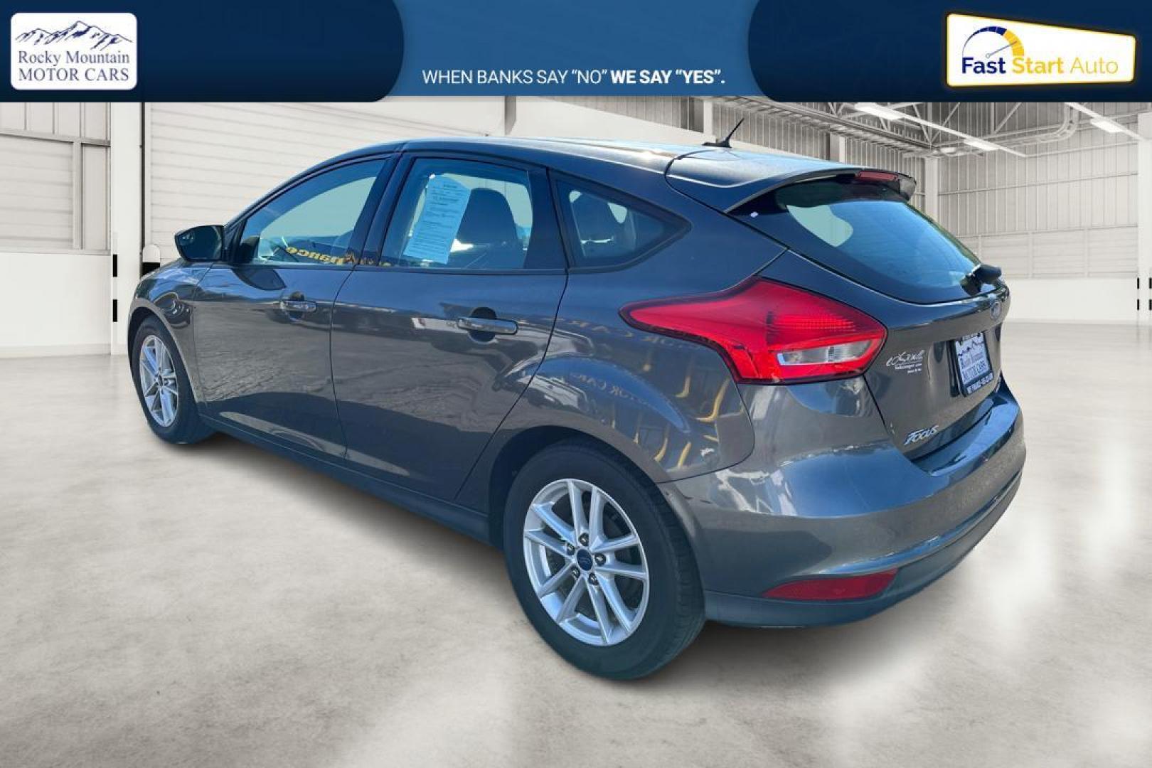 2015 Gray Ford Focus SE Hatch (1FADP3K22FL) with an 2.0L L4 DOHC 16V engine, 5-Speed Manual transmission, located at 344 S Washington Blvd, Ogden, UT, 84404, (801) 399-1799, 41.255482, -111.970848 - Photo#4