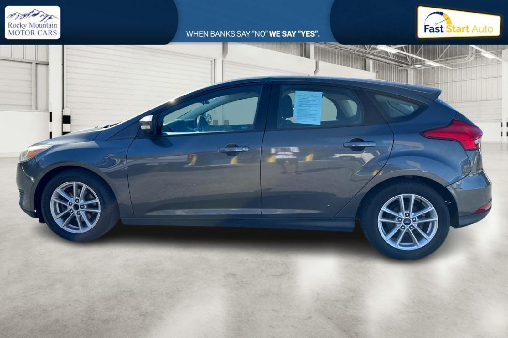 2015 Gray Ford Focus SE Hatch (1FADP3K22FL) with an 2.0L L4 DOHC 16V engine, 5-Speed Manual transmission, located at 344 S Washington Blvd, Ogden, UT, 84404, (801) 399-1799, 41.255482, -111.970848 - Photo#5