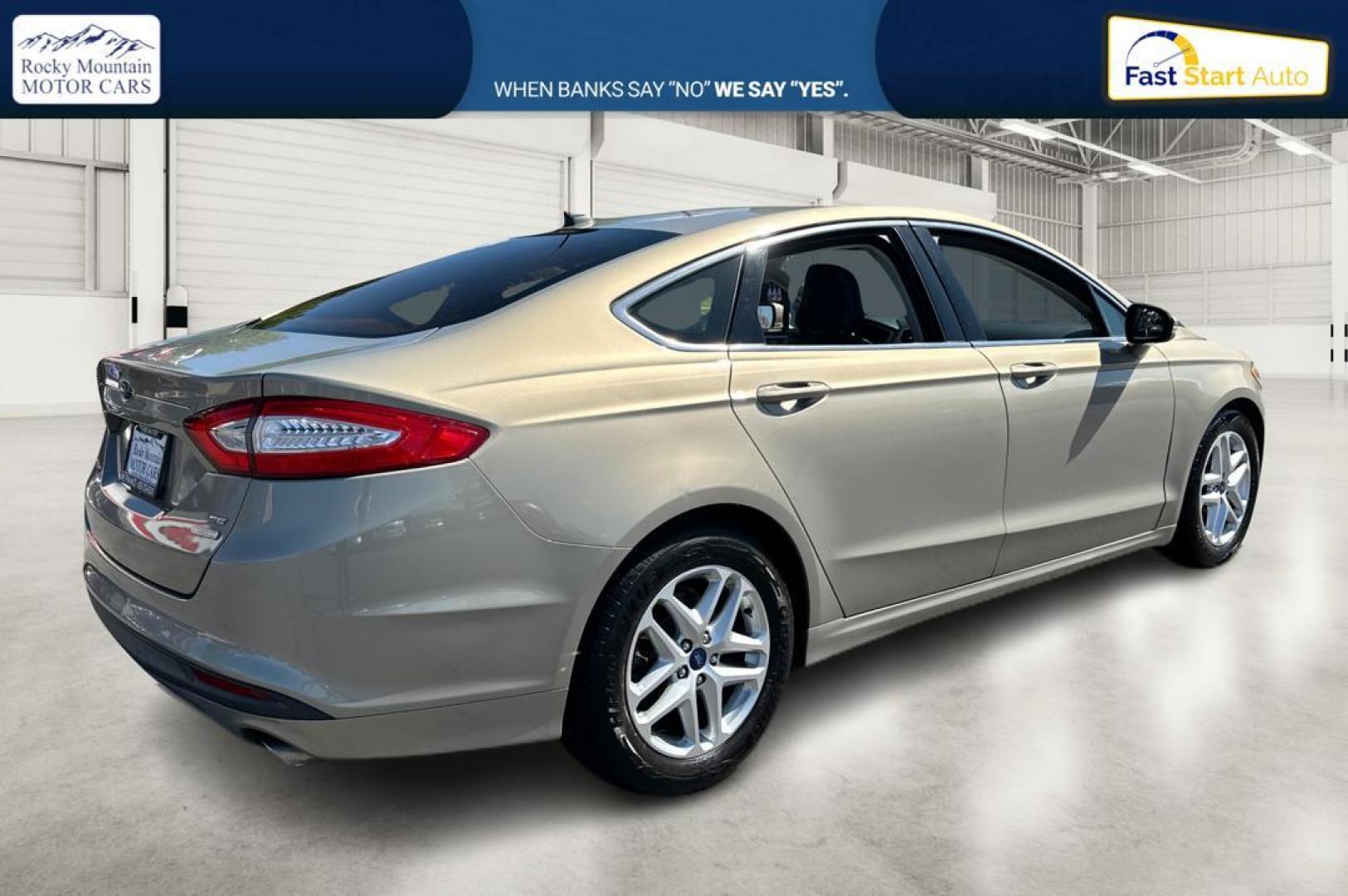 2015 Gray Ford Fusion SE (3FA6P0HDXFR) with an 1.5L L4 DOHC 16V engine, Auto, 6-Spd w/SelShft transmission, located at 344 S Washington Blvd, Ogden, UT, 84404, (801) 399-1799, 41.255482, -111.970848 - Photo#2