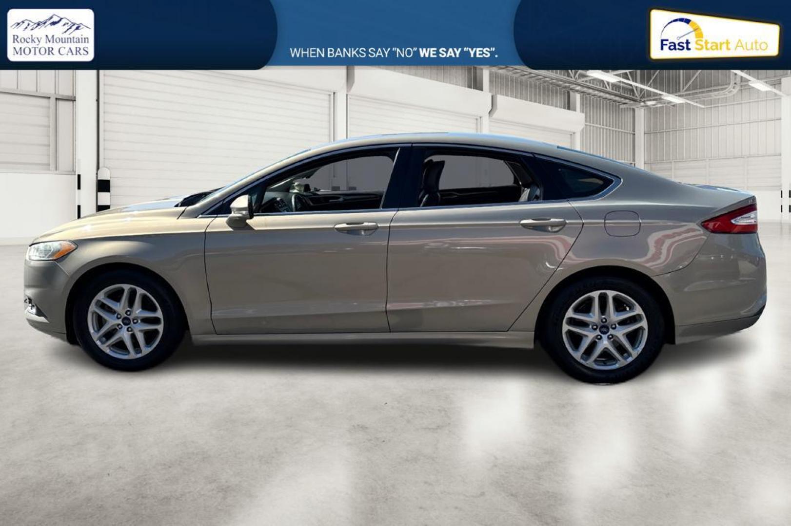 2015 Gray Ford Fusion SE (3FA6P0HDXFR) with an 1.5L L4 DOHC 16V engine, Auto, 6-Spd w/SelShft transmission, located at 344 S Washington Blvd, Ogden, UT, 84404, (801) 399-1799, 41.255482, -111.970848 - Photo#5