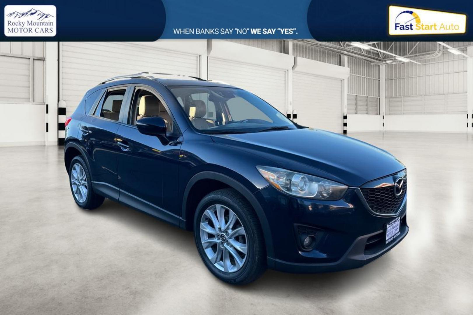 2015 Blue Mazda CX-5 Grand Touring (JM3KE2DY5F0) with an 2.5L L4 DOHC 16V engine, 6-Speed Automatic transmission, located at 344 S Washington Blvd, Ogden, UT, 84404, (801) 399-1799, 41.255482, -111.970848 - Photo#0