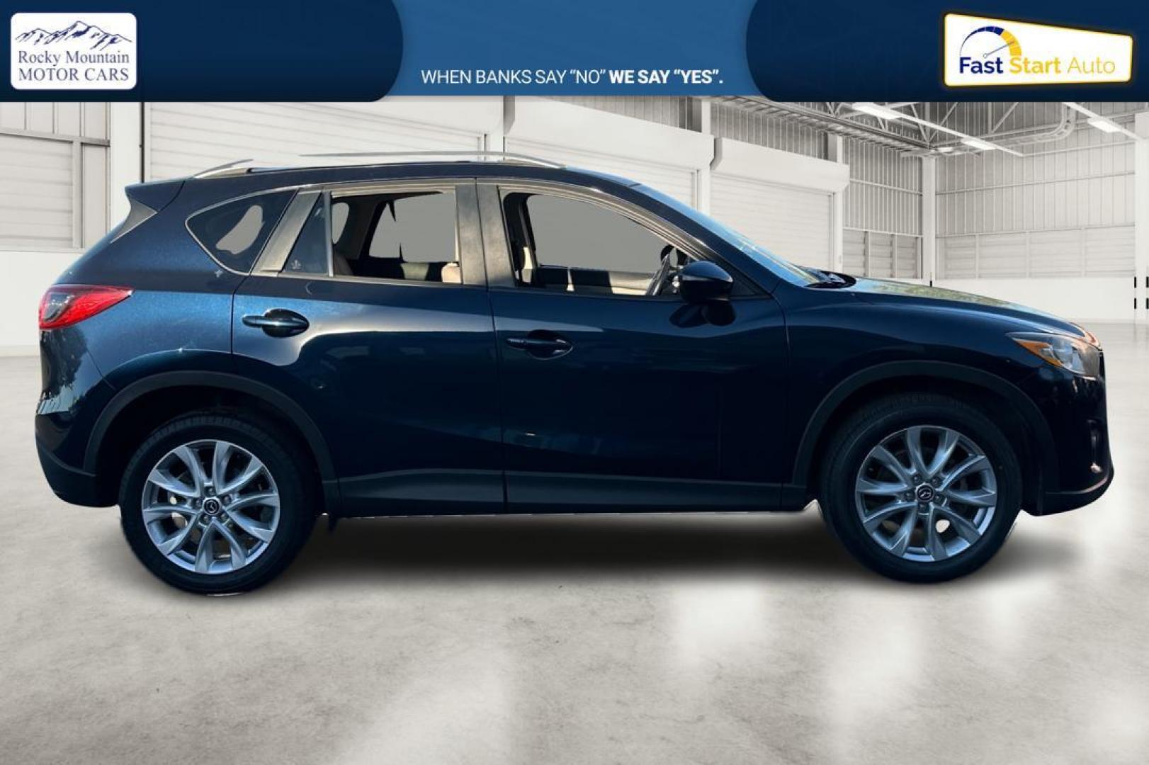 2015 Blue Mazda CX-5 Grand Touring (JM3KE2DY5F0) with an 2.5L L4 DOHC 16V engine, 6-Speed Automatic transmission, located at 344 S Washington Blvd, Ogden, UT, 84404, (801) 399-1799, 41.255482, -111.970848 - Photo#1