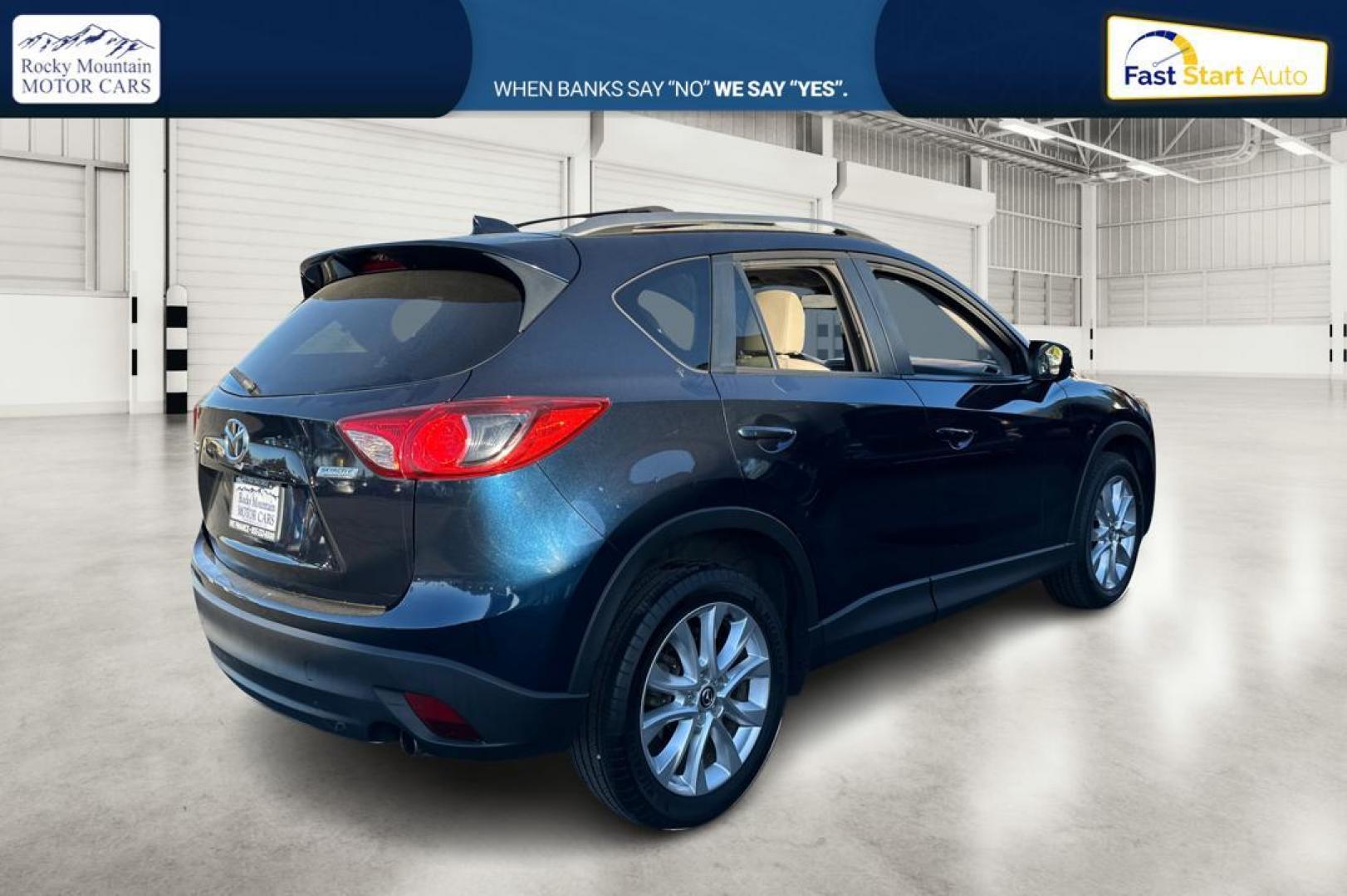 2015 Blue Mazda CX-5 Grand Touring (JM3KE2DY5F0) with an 2.5L L4 DOHC 16V engine, 6-Speed Automatic transmission, located at 344 S Washington Blvd, Ogden, UT, 84404, (801) 399-1799, 41.255482, -111.970848 - Photo#2