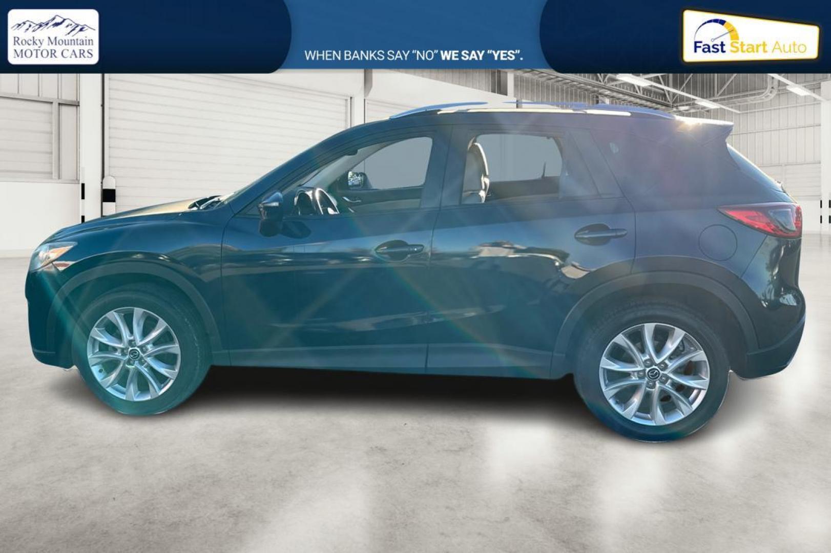 2015 Blue Mazda CX-5 Grand Touring (JM3KE2DY5F0) with an 2.5L L4 DOHC 16V engine, 6-Speed Automatic transmission, located at 344 S Washington Blvd, Ogden, UT, 84404, (801) 399-1799, 41.255482, -111.970848 - Photo#6