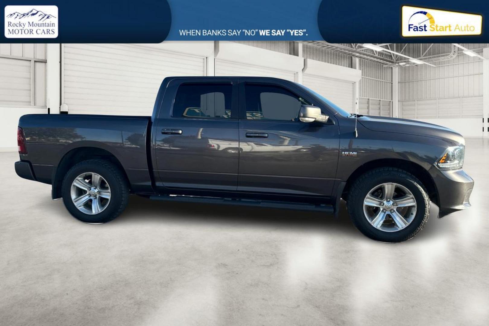 2015 Gray RAM 1500 Sport Crew Cab SWB 4WD (1C6RR7MT1FS) with an 5.7L V8 OHV 16V engine, 6-Speed Automatic transmission, located at 344 S Washington Blvd, Ogden, UT, 84404, (801) 399-1799, 41.255482, -111.970848 - Photo#1