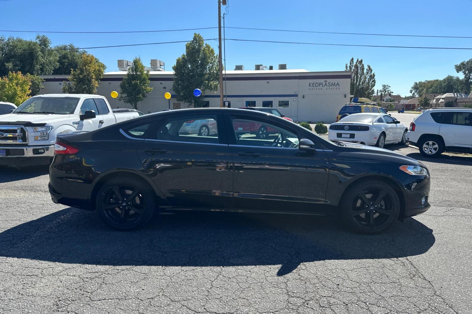 2016 Black Ford Fusion SE (3FA6P0HD8GR) with an 1.5L L4 DOHC 16V engine, 6-Speed Automatic transmission, located at 344 S Washington Blvd, Ogden, UT, 84404, (801) 399-1799, 41.255482, -111.970848 - Photo#1