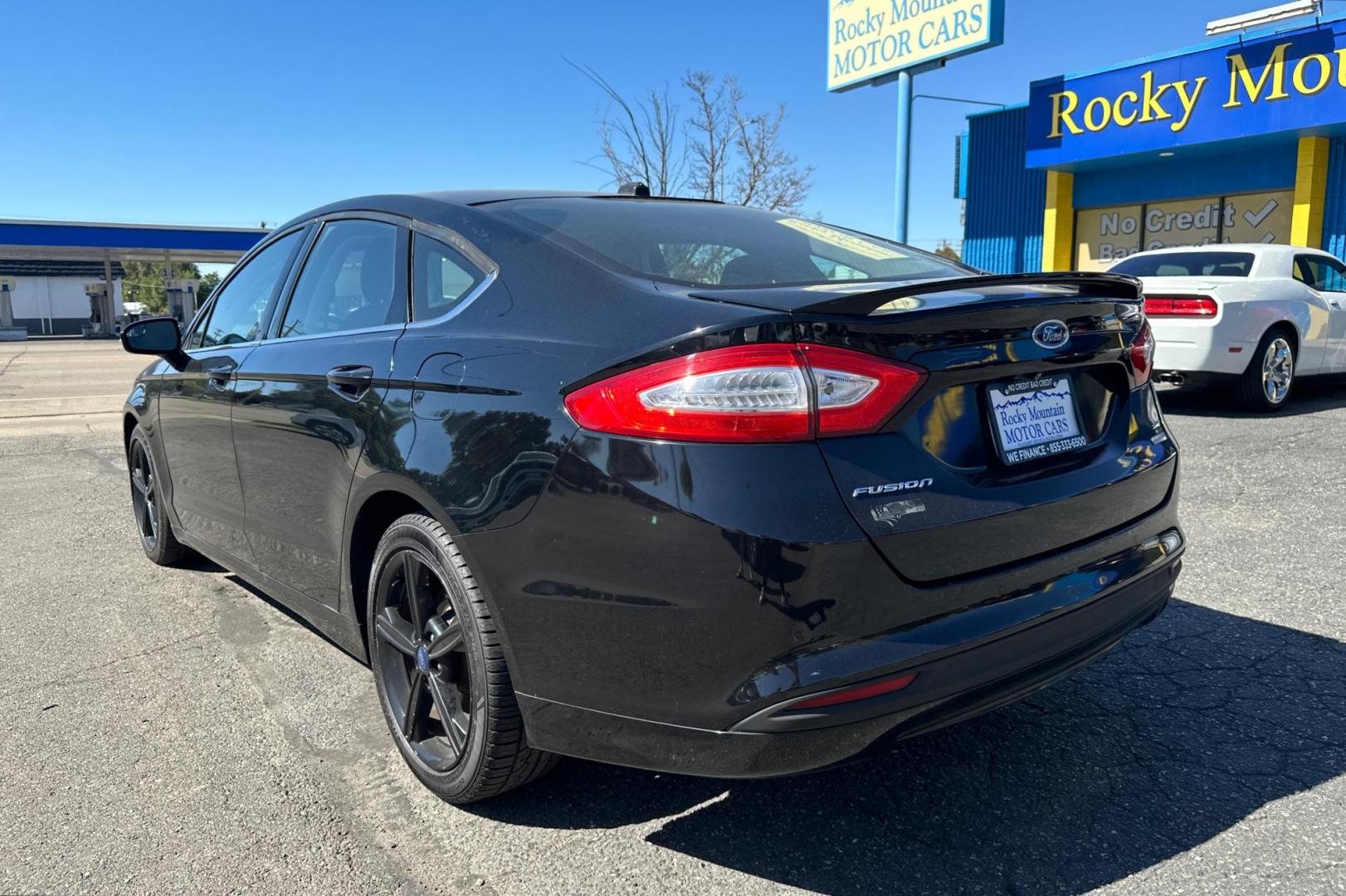 2016 Black Ford Fusion SE (3FA6P0HD8GR) with an 1.5L L4 DOHC 16V engine, 6-Speed Automatic transmission, located at 344 S Washington Blvd, Ogden, UT, 84404, (801) 399-1799, 41.255482, -111.970848 - Photo#4