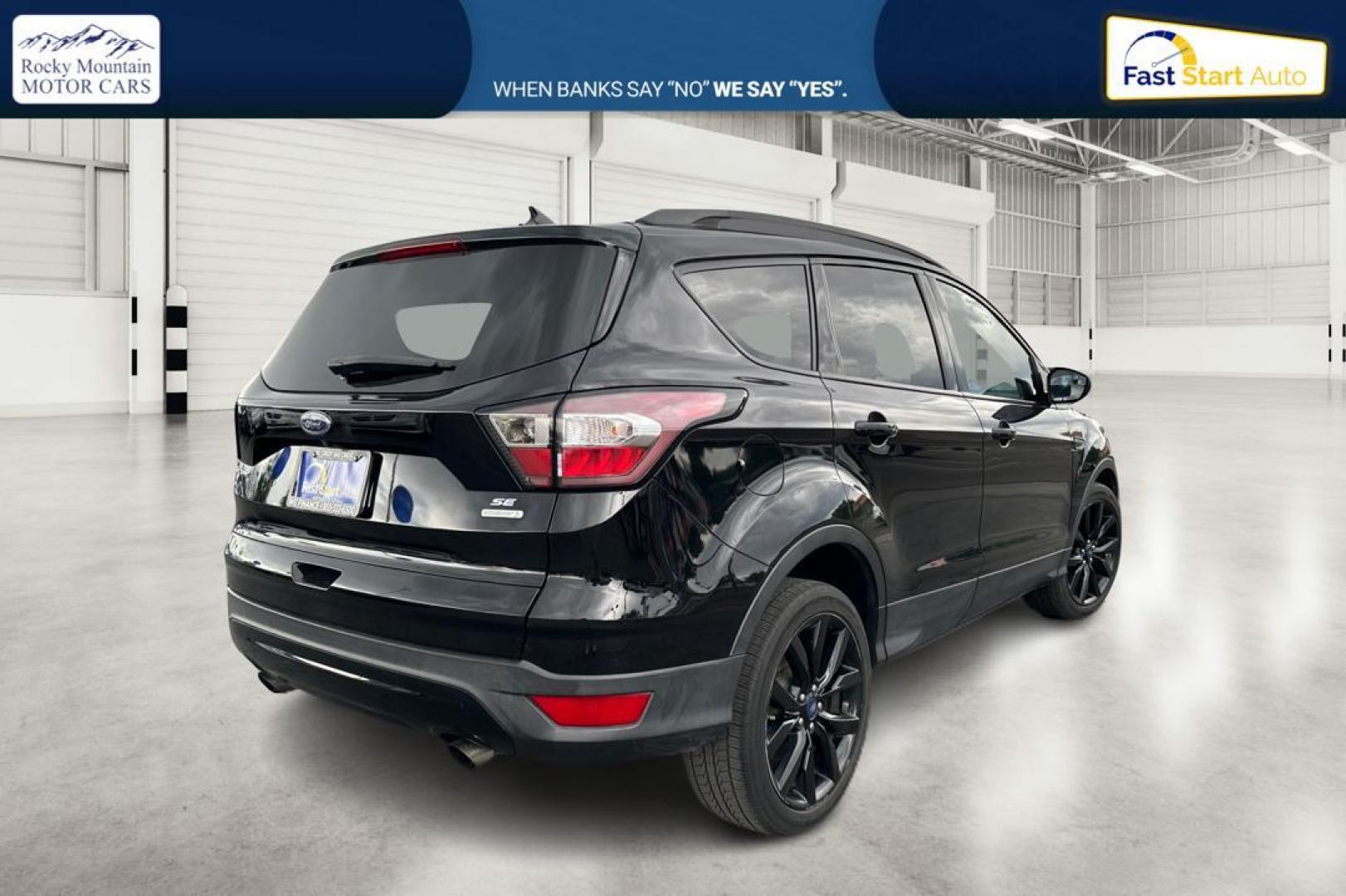 2018 Black Ford Escape SE FWD (1FMCU0GD9JU) with an 1.5L L4 DOHC 16V engine, 6A transmission, located at 7755 State Street, Midvale, UT, 84047, (801) 753-9063, 40.610329, -111.892159 - Photo#2